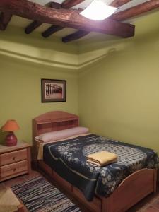 1 dormitorio con 1 cama y 1 mesa con lámpara en Casa Rural Hoces del Duratón El Villar Sepúlveda SEGOVIA, 