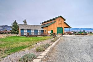 a barn with a green door on the side of it at Modern East Wenatchee Studio on Working Farm! in East Wenatchee