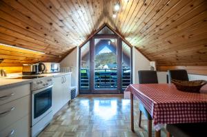 a kitchen with a table and a view of a mountain at Guest House Alenka in Bohinj