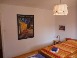 a bedroom with a bed and a poster on the wall at Haus Hollerbusch in Neunburg vorm Wald