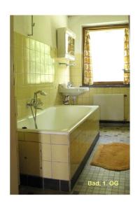 a bathroom with a tub and a sink at Haus Hollerbusch in Neunburg vorm Wald