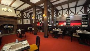 a restaurant with tables and chairs and a fireplace at Hôtel Bristol in Le Touquet-Paris-Plage