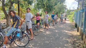 a group of people riding bikes down a sidewalk at Homestay Chez Moi in Can Tho