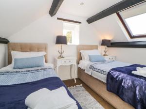 a bedroom with two beds and a window at The Holt in Sidmouth