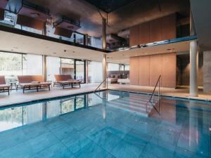 a large swimming pool in a building at Biohotel Rupertus in Leogang