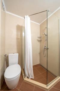 a bathroom with a toilet and a shower at Moana Lighthouse Apartment in Ahtopol +17 photos