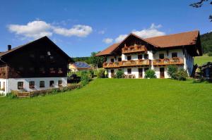 a large house with a green lawn in front of it at Beim Beckerbauern in Sankt Englmar
