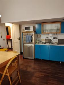 a kitchen with blue cabinets and a stove top oven at residenza San Martino in Naples