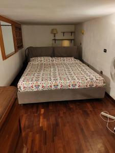 a large bed in a bedroom with wooden floors at residenza San Martino in Naples