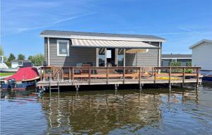 a house on a dock on a body of water at Lovely Home In Breukelen With House Sea View in Breukelen
