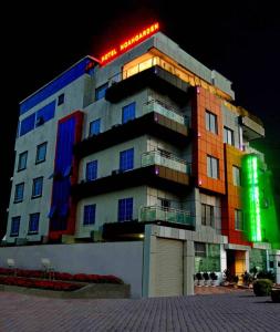 a large building is lit up at night at Noahgarden Hotel in Cotonou