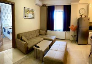 a living room with a couch and a table at Central City in Kutaisi +7 photos