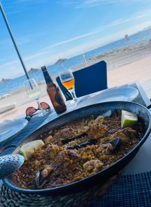 a pan of food on a table at the beach at Lo Pagan Beachfront Aircon Apartment in San Pedro del Pinatar