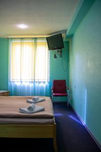 TV a/nebo společenská místnost v ubytování Olimpija Hotel & SPA + 21 fotografií