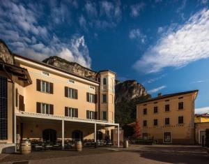 a building with a mountain in the background at Albergo Caffe Centrale in Mezzocorona