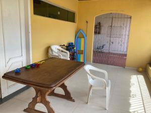 a dining room with a wooden table and white chairs at Ilha de Mosqueiro Belém do Para Casa de praia no Ariramba l in Belém +12 photos