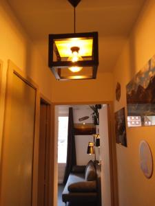 Résidences de Mélisa La Foux d'Allos في لا فوكس: ضوء يتدلى من السقف في غرفة مع أريكة