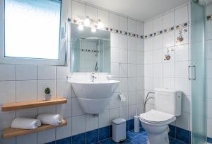 a bathroom with a sink and a toilet at Elyzabeth Maisonette in Agios Nikolaos +7 photos