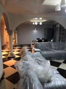 a living room with two couches and a table at Well presented apartment with 2 master bedrooms. in Freetown