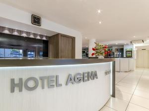 a hotel agenciana sign in a hospital lobby at Hôtel Agena in Lourdes