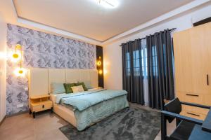 a bedroom with a bed and a window at Lighthouse Signature Suites in Dakar