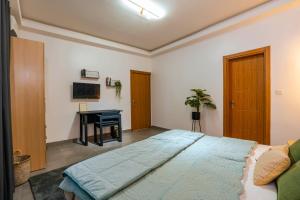 a bedroom with a large bed and a desk at Lighthouse Signature Suites in Dakar