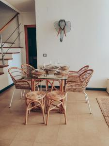 a dining room with a wooden table and chairs at Casa Aloe Vera in Cotillo +58 photos