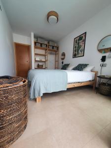 a bedroom with a bed and a basket at Casa Aloe Vera in El Cotillo