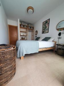 a bedroom with a bed and a basket at Casa Aloe Vera in El Cotillo +58 photos
