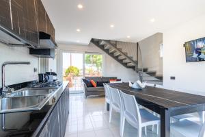 a kitchen with a sink and a counter top at Villa Cisa in Lignano Sabbiadoro