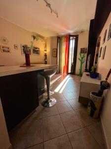 a kitchen with a counter and a table in a room at Catania Duomo Shine in Catania
