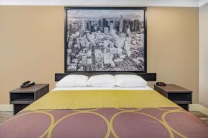 a bedroom with a large painting above a bed at Super 8 by Wyndham North Hollywood in North Hollywood