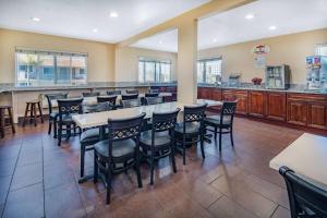 a restaurant with a bar with chairs and tables at Super 8 by Wyndham San Diego Hotel Circle in San Diego