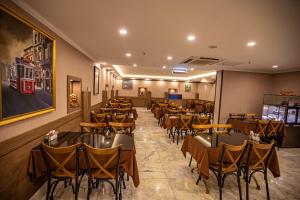 a restaurant with tables and chairs in a room at Hamitbey Hotel Yenikapı in Istanbul