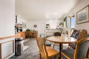 a kitchen and living room with a table and chairs at Econo Lodge Bartlesville Hwy 75 in Bartlesville