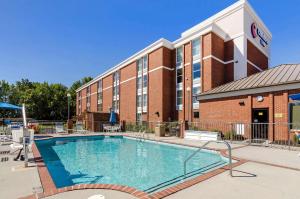 a hotel with a large swimming pool in front of a building at Comfort Inn Blacksburg University Area in Blacksburg