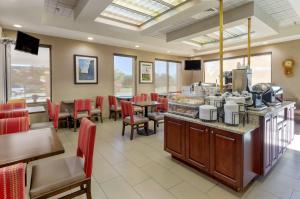 a restaurant with a counter and tables and chairs at Comfort Inn Blacksburg University Area in Blacksburg