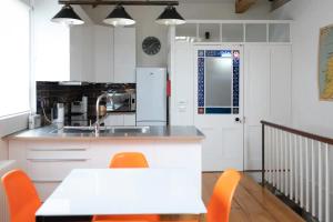 a kitchen with a table and chairs and a refrigerator at The Brew House in Bath +7 photos