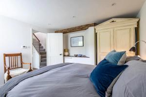 a bedroom with a bed with blue pillows at The Brew House in Bath