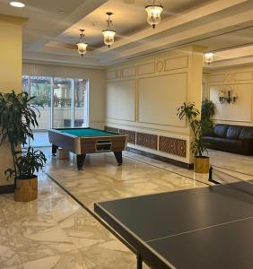 a large room with a pool table in it at Beachfront Luxury Apartment-The Home-Pearl Island in Doha