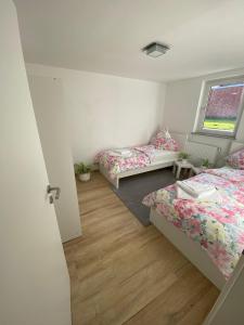 a bedroom with two beds and a window at Kiefern Apartments in Hannover