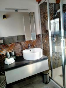 a bathroom with a sink and a mirror at Cozy Home Maison Cascina Amélie in Abbadia Lariana +27 photos