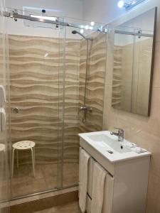 a bathroom with a sink and a shower at GuestHouse Marquês in Porto +34 photos