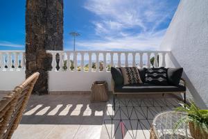 a bench on a balcony with a view of the ocean at Casa Tucanes in Puerto del Carmen