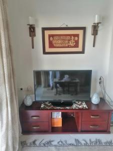 a dresser with a tv on top of it at Aqua marine - comfort vacation home with pool view in Sharm El Sheikh