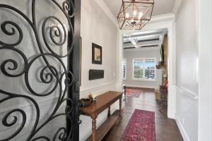 a hallway with a table and a wrought iron door at Tres A Lake Retreat in Canyon Lake