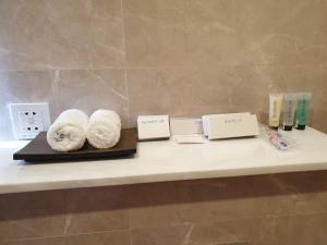 a counter with towels and other items on it at Terminal Inn Fully Furnished Hotel & Apartment- Al Mansoura in Doha