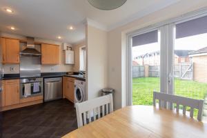 a kitchen with a dining room table and a window at Hillbrook in Thornaby on Tees