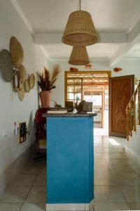 a kitchen with a blue island in a room at Conves suites in Penha