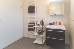 un piccolo bagno con lavandino e specchio di SiebenSiel in Greetsiel a Krummhörn